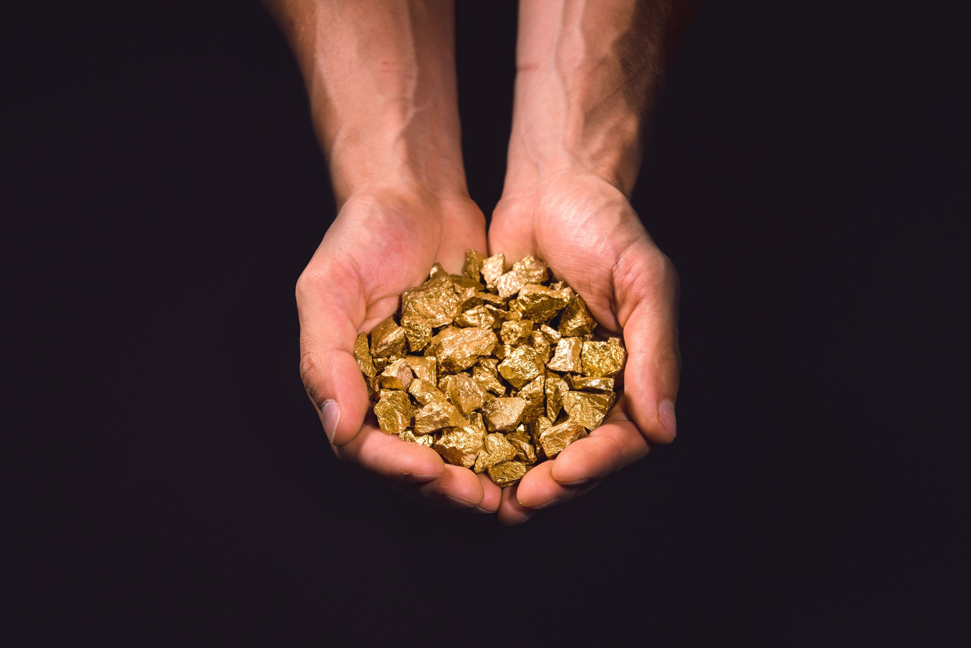 Gold nuggets in human hands